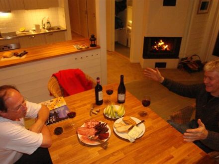 two men talking while eating