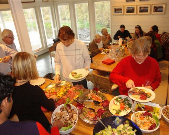 People on about the buffet table People on about the buffet table