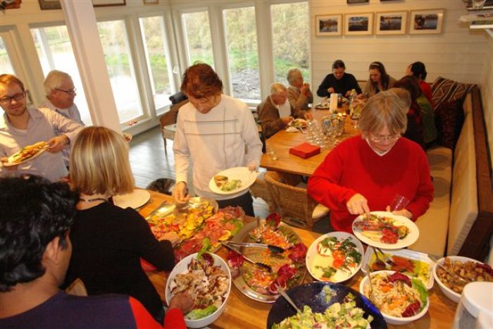 people over a buffet table